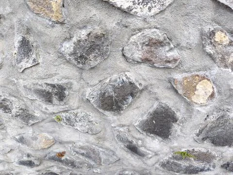 ​Natural stone wall texture background with grey cement mortar. Stock Photos