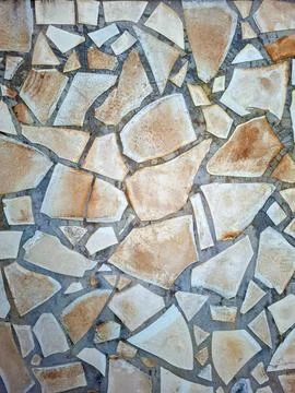 Natural stone wall texture featuring a unique pattern of earthy colors and .. Stock Photos