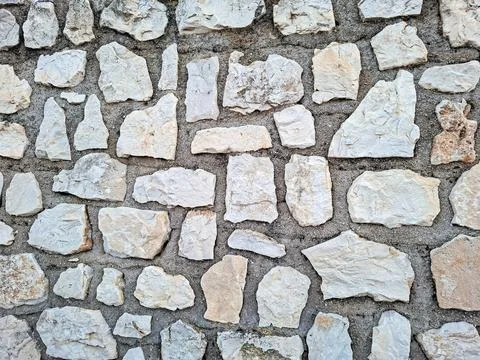 Natural stone wall texture before final plastering showcasing unique shapes.. Stock Photos