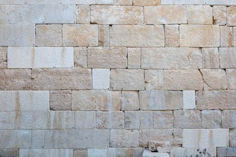 Natural stone wall texture with rectangular blocks in warm earth tones Stock Photos