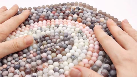 Natural striped agate gemstone round beads polished for jewelry design projects Stock Footage 345139617