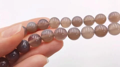 Natural striped agate gemstone round beads polished for jewelry design projects Stock Footage 345139643