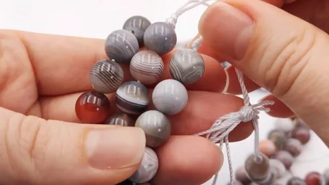 Natural striped agate gemstone round beads polished for jewelry design projects Stock Footage 345139688