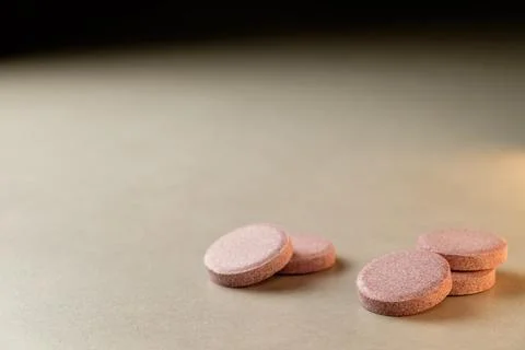 Natural supplements resting on a smooth surface illuminated by soft light Stock Photos