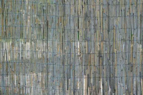Natural texture of bamboo in woven patterns near a tranquil garden 스톡 사진