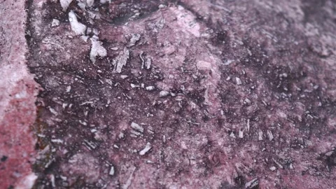Natural texture of raw pink stone interspersed with white marble. slow motion. Stock Footage 229779956