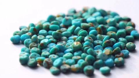 A natural turquoise stone close-up in form of a heap or slide is spinning 库存影片 121560213
