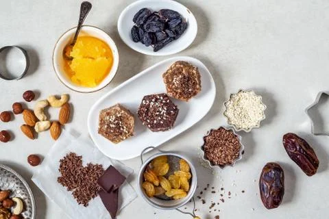 Natural useful sweets from dates, nuts, honey and raisins on a white plate Stock Photos