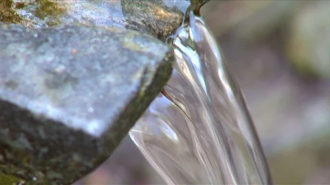 Natural water source with stone channel. Natural spring of water Stock Footage 89507538