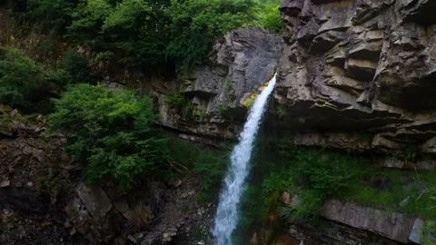 Natural Waterfall Flowing Into Rocky Stream In Lush Green Forest Stock Footage 342214964