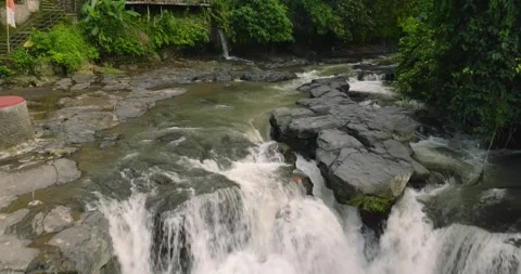 Natural waterfall in a forest setting. Slow motion. Zoom in Stock Footage 310386143