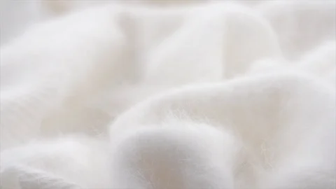 Natural white Cashmere Soft, fluffy merino wool closeup. Slow motion Video stock 106936852