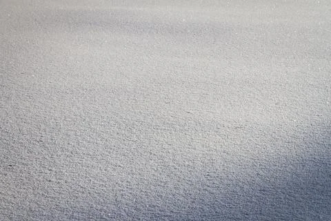 Natural winter backdrop featuring white snow texture Stock Photos