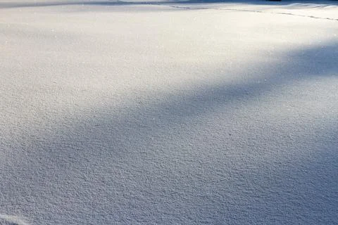 Natural winter backdrop featuring white snow texture Stock Photos