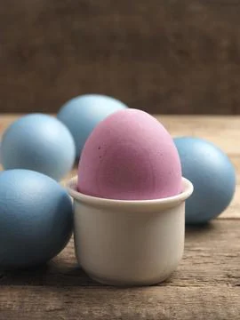 Naturally colored organic eggs on a rustic table with space for text, Easter Stockfoto's