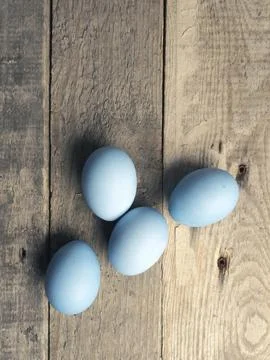 Naturally colored organic eggs on a rustic table with space for text, Easter Stockfoto's