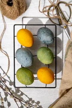 Naturally dyed colorful easter eggs drying on a cooling rack, spring holida.. Stock Photos