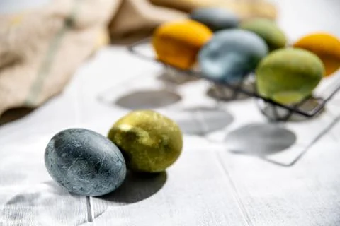 Naturally dyed easter eggs drying on a white wooden table, creating a festi.. Stock Photos
