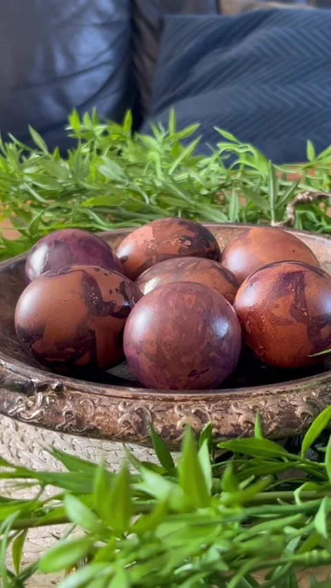 Naturally dyed Easter eggs with marbled brown and plum patterns arranged in an Stock Footage 335946078