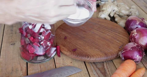 Naturally fermented red beet root kvass preparing, adding salt Stock Footage 303670089