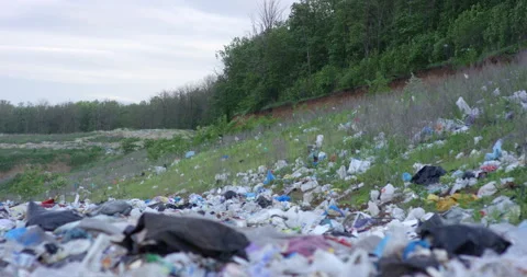 Nature with abandoned waste dump on cloudy sky horizon. Filmed in slow motion Stock Footage 155728824