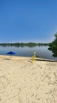 Nature and empty beach on the river. Preparing for the summer season. Reflect Fotos de archivo