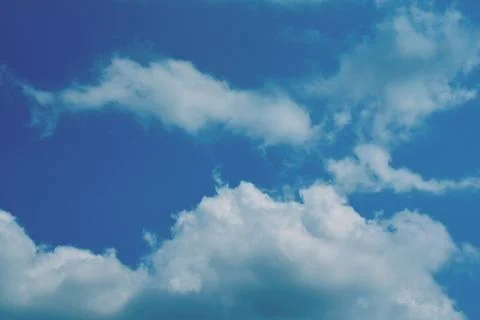 Nature background. Fluffy soft clouds in sky toned. Stockillustratie