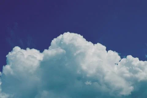 Nature background. Fluffy soft clouds in sky toned. Stockillustratie