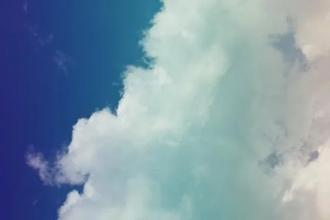 Nature background. Fluffy soft clouds in sky toned. Stockillustratie