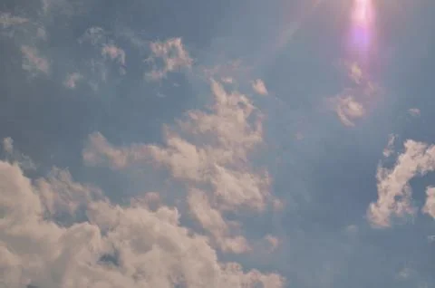 Nature background. Fluffy soft clouds in sky toned. Stock Photos