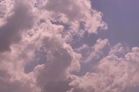 Nature background. Fluffy soft clouds in sky toned. Stock Photos