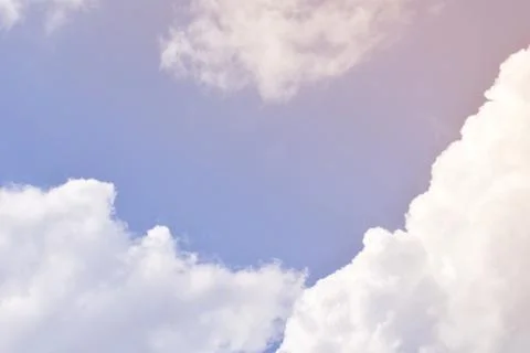 Nature background. Fluffy soft clouds in sky toned. Stock Photos