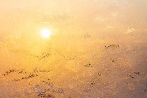 Nature background with ice pattern and sunlight on winter window Stock Photos