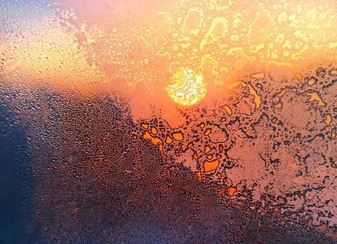 Nature background with ice pattern, bright sunlight and water drops on win... Stock Photos