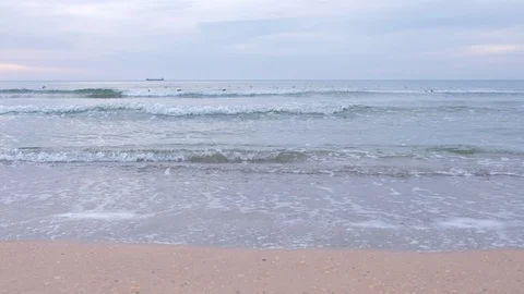 Nature background with sandy sea beach, small foam long waves, birds at sunset. Video stock 117907715
