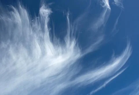 Nature background of torn clouds in a blue sky Stock Photos