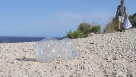 Nature cleaning, stop plastic, environmental concept. Volunteer kid raises and Stock Footage 131496610