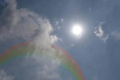 Nature cloudscape with blue sky and white cloud with rainbow. Rainbow in th.. Stock Illustration
