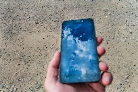 Nature concept - blue sky and cloud reflection in mobile phone Stock Photos