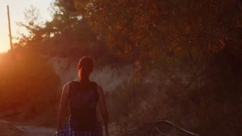 Nature explorer hiking through mountain forest at sunset, wanderlust concept Stock Footage 229327706