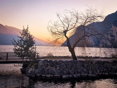 Nature frames the panorama of the sunset over Lake Garda Stock Photos