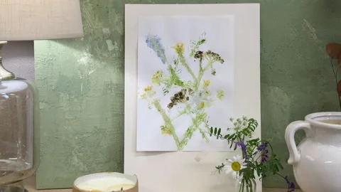 Nature-inspired flower print displayed in cozy interior with soft lighting, rust 库存影片 311753716