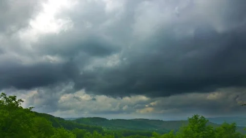 Nature landscape cumulus clouds rolling over hills and mountains time-lapse Video stock 243900038