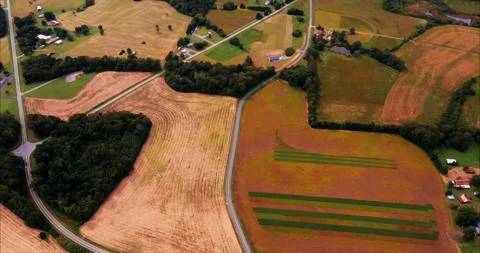 Nature mosaic in a patchwork of field shapes, sizes, colors, and roads Stock Footage 139987300