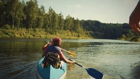 Nature Package 22 | backpackers going off coastline on canoe boat in river Stock Footage 119155901