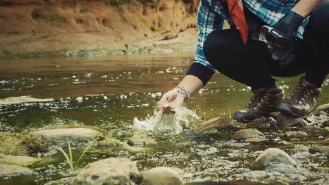 Nature Package 30 | hiker backpacker stopping at river to wash his face Video stock 119156550