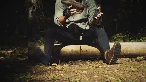 Nature Package 9 | hiker backpacker sitting on piece of wood emptying shoe Stock Footage 119155311