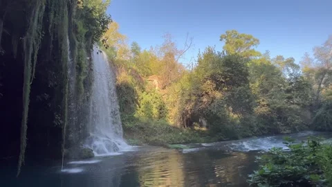 Nature scenery with a waterfall in front of a cave Stock Footage 337003110