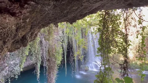 Nature scenery with a waterfall in front of a cave Stock Footage 337003898