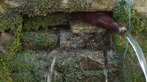 Nature - Shot of springwater source with a bottle Stock Footage 118979197